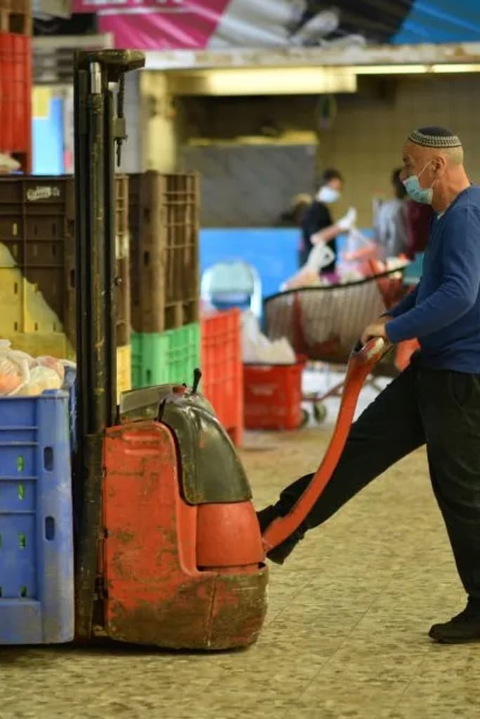 A volunteer using a crane