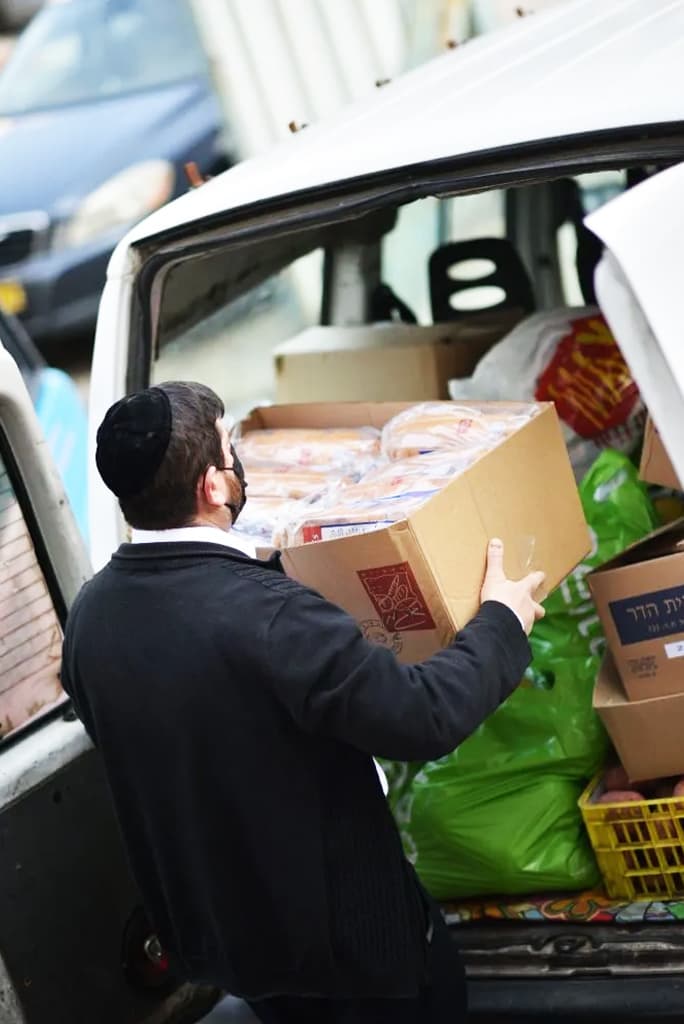 A volunteer loading a delivery van